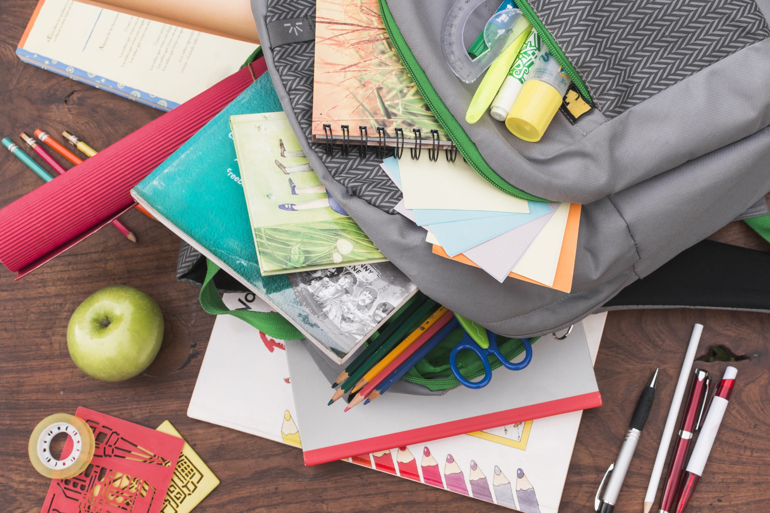 Empty school backpack with books and pens